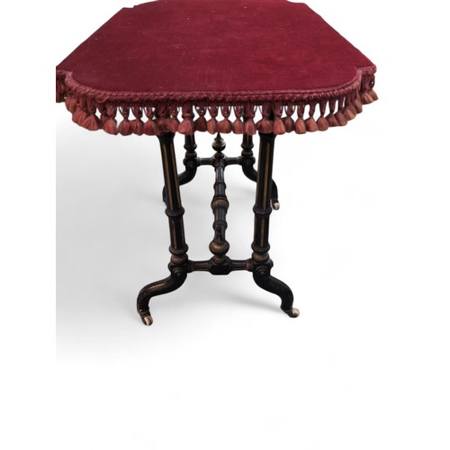 60 - Victorian ebonised side table on casters with a replacement fringed velvet top. W872cm D31cm H65cm.