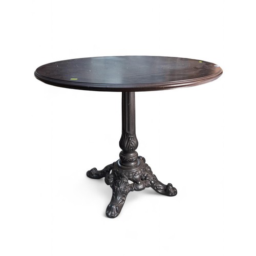 113 - Circular table on ornate cast iron pedestal. Diameter 90cm H67cm.