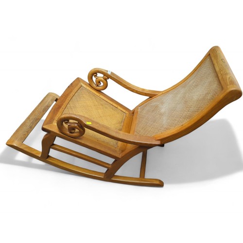 84 - South East Asian-style rocking chair with rattan seat and back. W57cm D110cm H92cm.