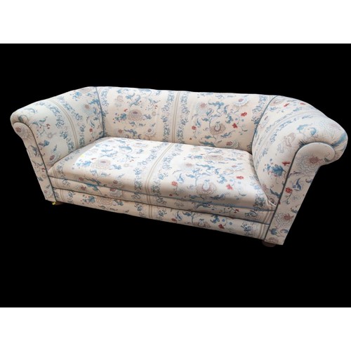 119 - Horsehair-filled Chesterfield-style sofa with cream, blue and pink upholstery. W185cm D86cm H76cm.