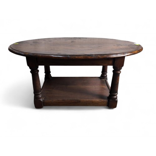 121 - Oval hardwood 2 tier coffee table. W86cm D54.5cm H40cm.