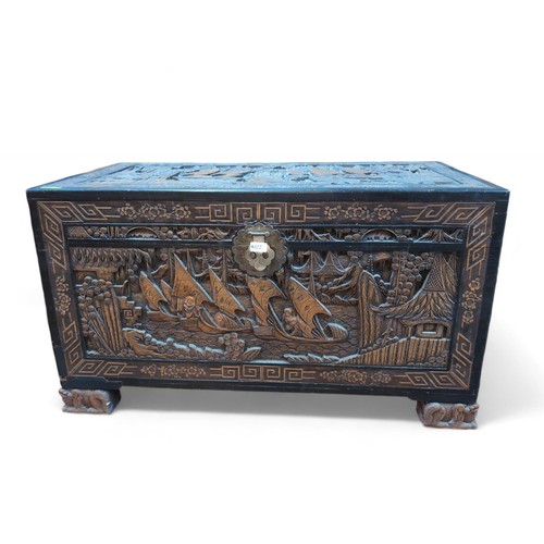 122 - Camphor wood carved Asian chest depicting junks and landscapes. W106.5cm D55cm H60cm. Raised on Fo d... 