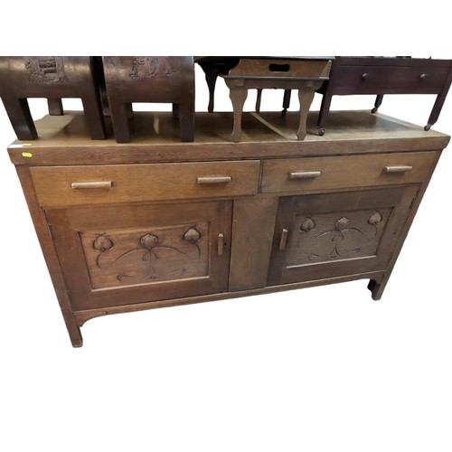 124 - Solid oak sideboard with 2 drawers over cupboard base with art nouveau panels. W173cm D55.5cm H99cm.