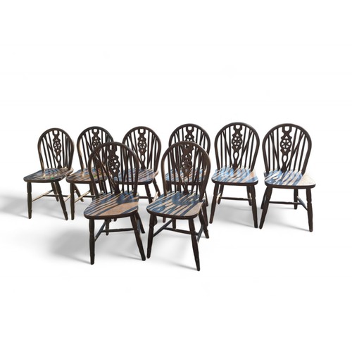 129 - Set of 8 wheel back dining chairs.