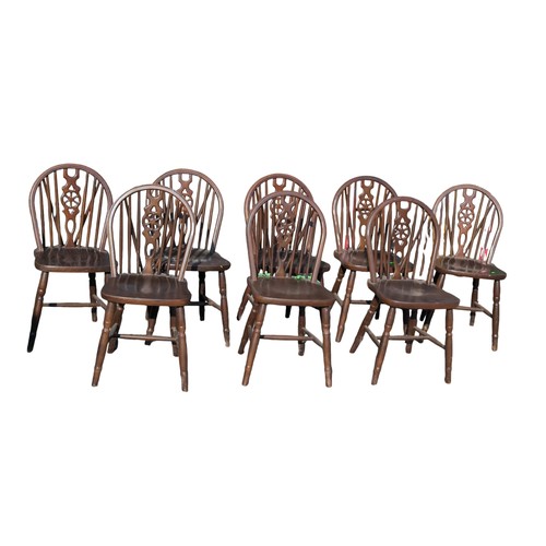 129 - Set of 8 wheel back dining chairs.