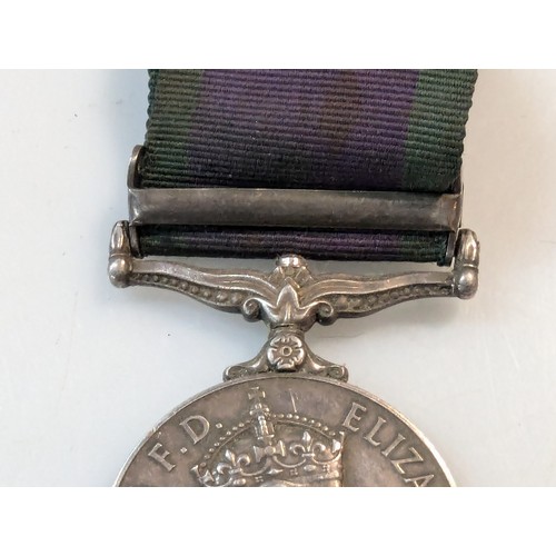 387A - Pewter plate with various militaria inc: ERII campaign medal, dogtags, military buttons and badges.