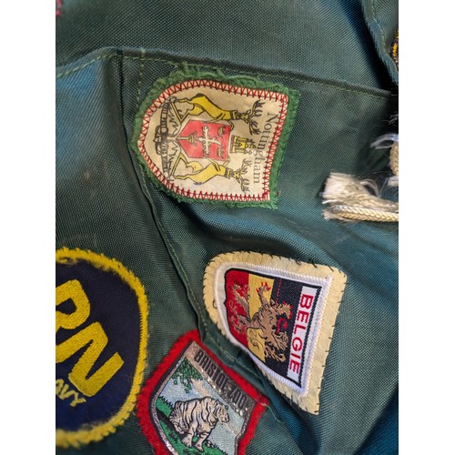 116 - Box of Scout uniform, progress book etc with various badges attached.