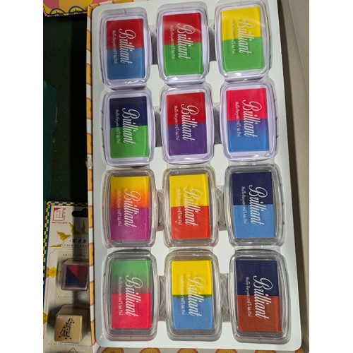 175 - Crate of various sized ink stamps + ink pads. Crate not included.