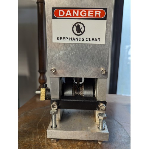 185 - Large bench-mounted hand-turned wire stripper. 