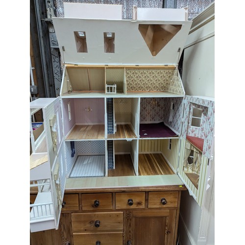 957 - Large wooden doll's house with four bedrooms W82 x D54 x H81cm