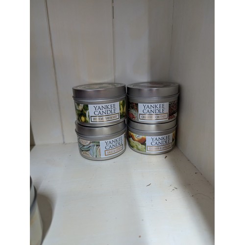 926 - Four tinned Yankee Candles, new and unused