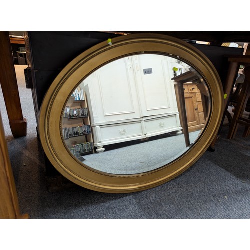 984 - Gilt framed oval bevelled mirror 87 x 25cm