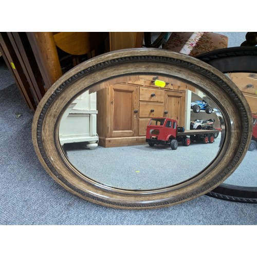 986 - Two bevelled oval framed mirrors, largest 61 x 52cm