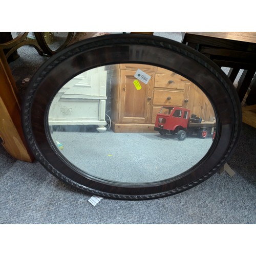 986 - Two bevelled oval framed mirrors, largest 61 x 52cm