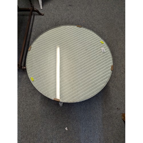 851 - Lloyd Loom white painted circular two tier coffee table, with glass top, diameter 59cm, height 47cm