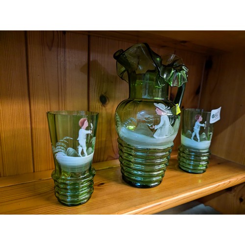 862 - Mary Gregory style green glass jug and two glasses, height of jug 18.5cm