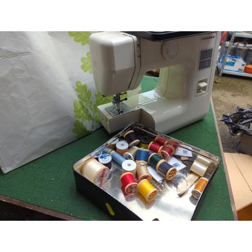 241 - Janone electric sewing machine with cloth cover, attachments and instructions, cottons, threads etc.