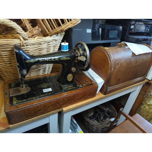 299 - Manual Singer sewing machine with case.