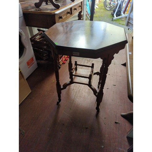 340 - Octagonal occasional table on casters. Diameter 58cm H72cm.