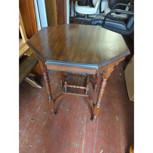 340 - Octagonal occasional table on casters. Diameter 58cm H72cm.