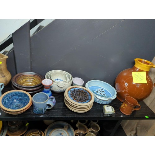 795 - Qty of assorted studio pottery over two shelves