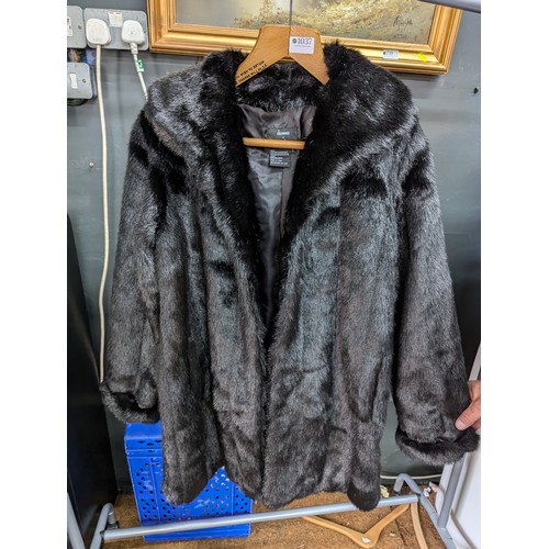 1037 - Faux fur ladies 3/4 length overcoat and three other garments, some with tags