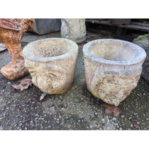 532 - Pair of concrete planters with facial fronts. H20cm.