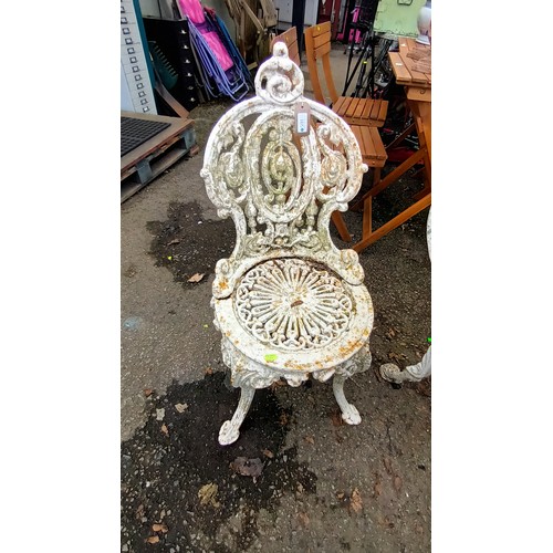 591 - Early C.20th cast iron table and 2 chairs with lion's head detail to table base. Table diameter 68cm... 