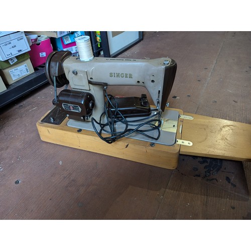 240 - Singer electric sewing machine in case with pedal.