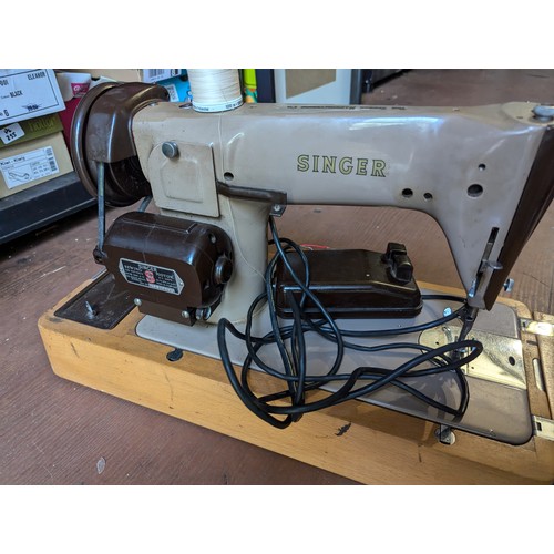 240 - Singer electric sewing machine in case with pedal.