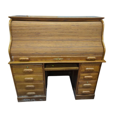 21 - Large bureau with tambour front. W138cm D72cm H135cm.