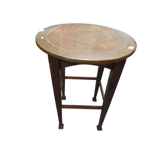 65 - Arts and Crafts style circular occasional table with beaten copper top on tapering supports with typ... 