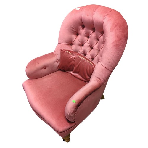 73 - A pink upholstered button back low armchair