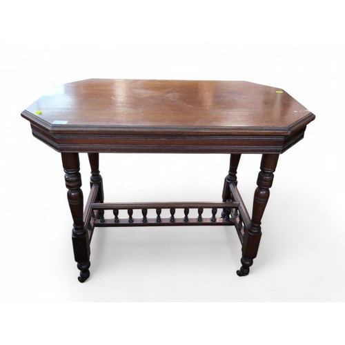 93 - Octagonal mahogany occasional table on casters. W92cm D53cm H73cm.