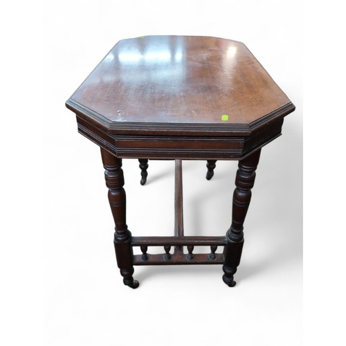 93 - Octagonal mahogany occasional table on casters. W92cm D53cm H73cm.