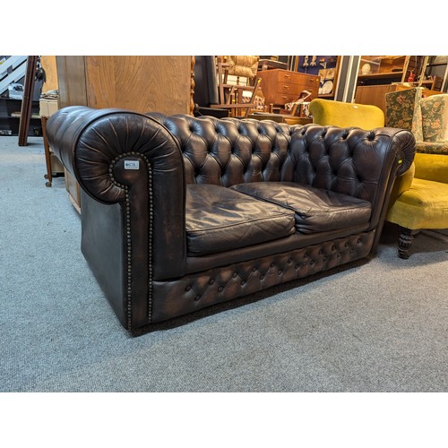Button back leather Chesterfield style sofa with feathered cushions, width 163cm, depth 86cm, height 70cm