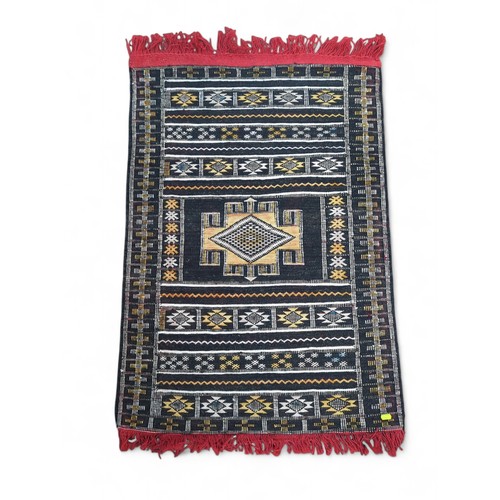 896 - Turkish style central medallion rug with tasselled ends, 74 x 110cm