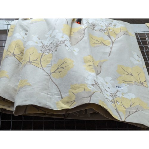 898 - Two pairs of Laura Ashley curtains depicting flora in shades of yellow and white, each curtain with ... 