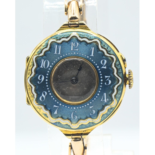 24 - 18ct gold and enamel cased ladies watch, silver dial, with blue and white enamel surround with Arabi... 