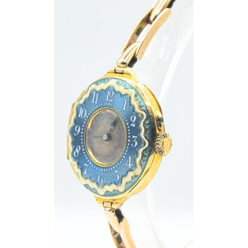 24 - 18ct gold and enamel cased ladies watch, silver dial, with blue and white enamel surround with Arabi... 