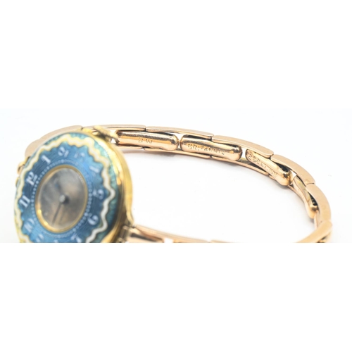 24 - 18ct gold and enamel cased ladies watch, silver dial, with blue and white enamel surround with Arabi... 