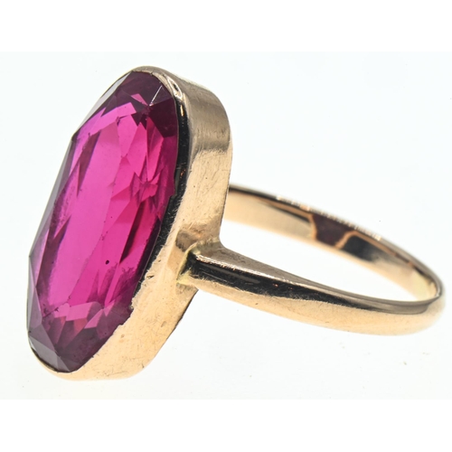 45 - Yellow metal mounted oval-shaped synthetic ruby ring, faint marks to back of shank, tests positive f... 