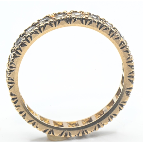 64 - 9ct gold and white stone eternity ring, stamped 9ct, size N1/2, gross weight 2.11 grams