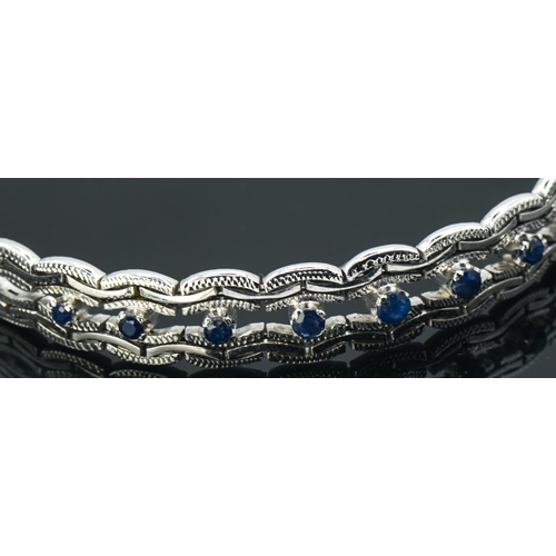 81 - 14ct white gold and sapphire bracelet, stamped 585, length 190mm, gross weight 18.83 grams