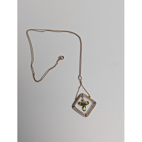 93 - 9ct gold, peridot and seed pearl pendant with a 9ct gold trace chain, stamped 9CT, pendant length 49... 