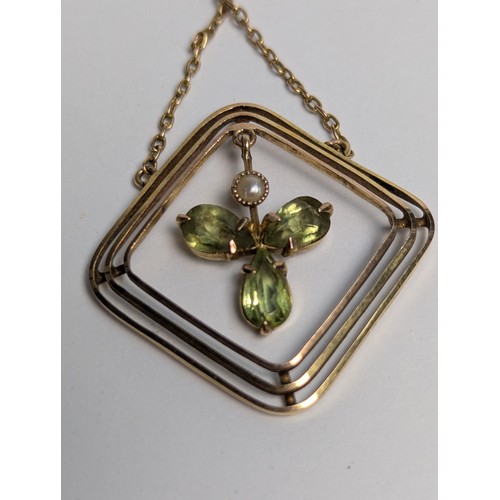 93 - 9ct gold, peridot and seed pearl pendant with a 9ct gold trace chain, stamped 9CT, pendant length 49... 