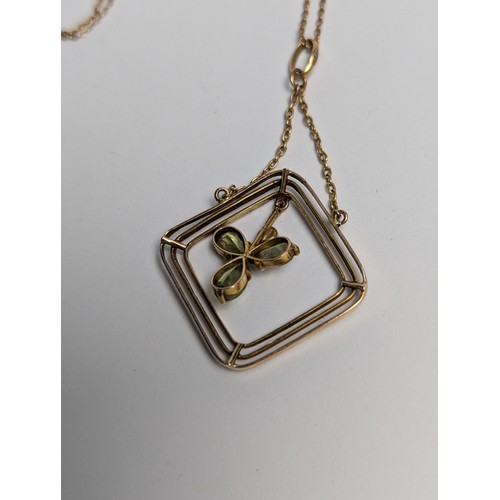 93 - 9ct gold, peridot and seed pearl pendant with a 9ct gold trace chain, stamped 9CT, pendant length 49... 