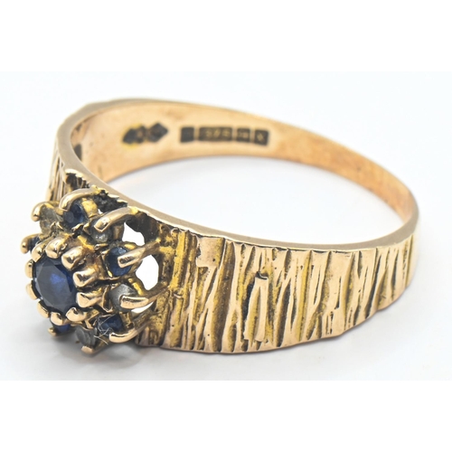 141 - 9ct gold ring with bark style finish and central cluster with sapphire, size R, gross weight 3.39 gr... 