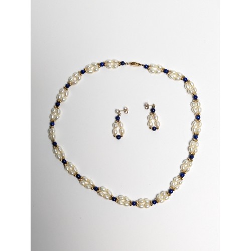 153 - Freshwater pearl and lapis lazuli necklace and pair of pendant earrings, each with 14ct gold fitting... 