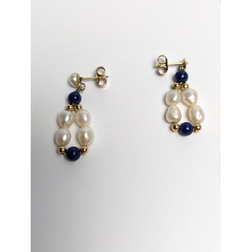 153 - Freshwater pearl and lapis lazuli necklace and pair of pendant earrings, each with 14ct gold fitting... 